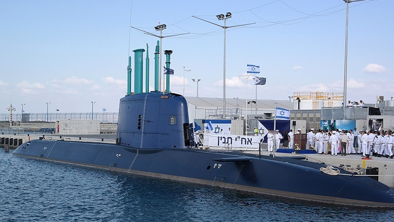 Submarine half submerged at a shipyard.